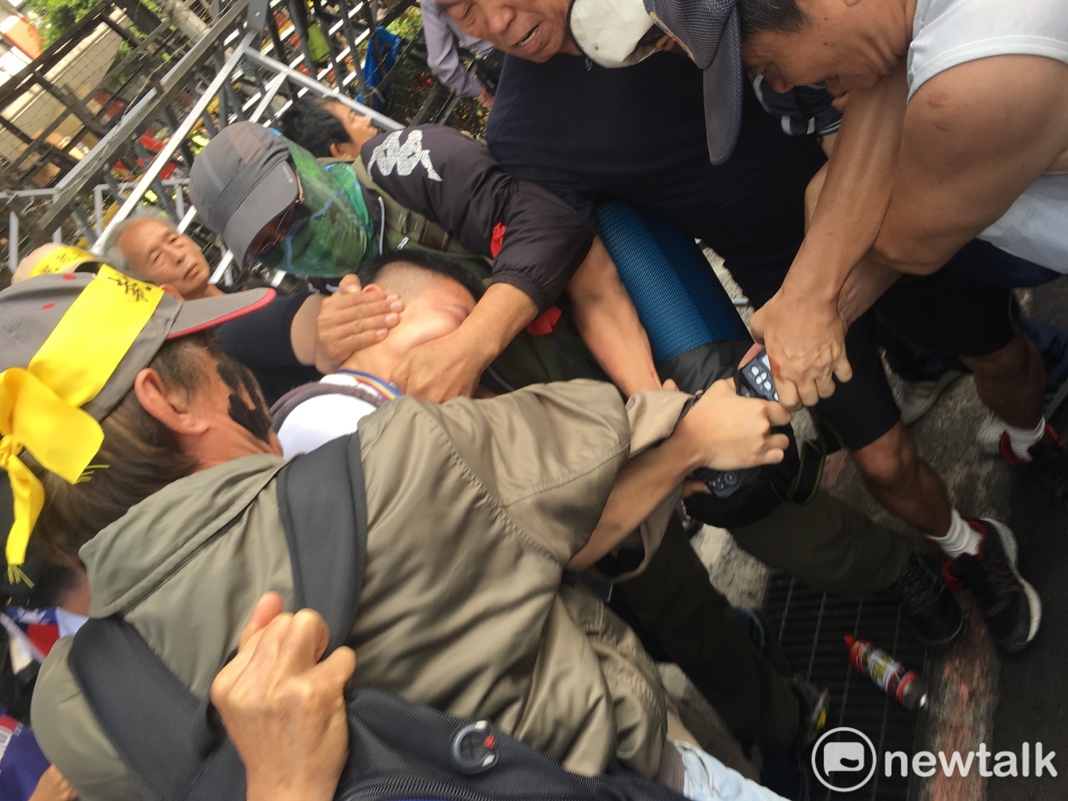 民報記者鍾孟軒25日下午被反年改團體圍毆,搶奪相機。 民報記者鍾孟軒25日下午被反年改團體圍毆,搶奪相機。