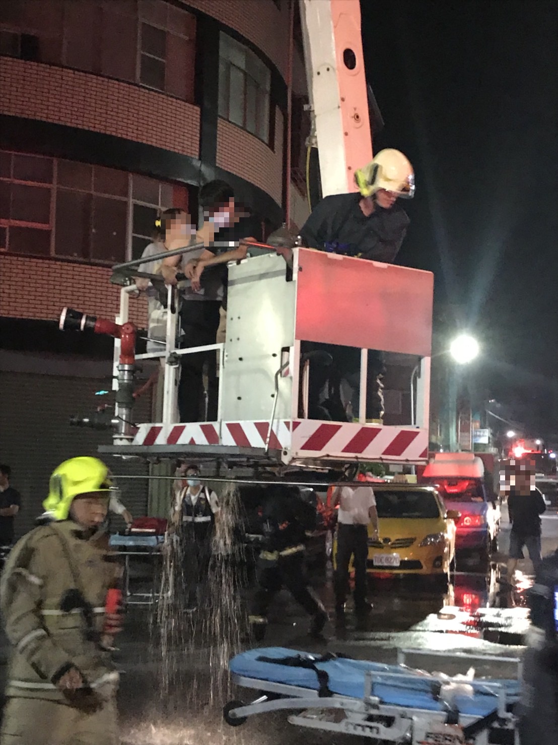 雲梯車救出多名受困住戶。 圖/高雄市消防局提供 雲梯車救出多名受困住戶。 圖/高雄市消防局提供