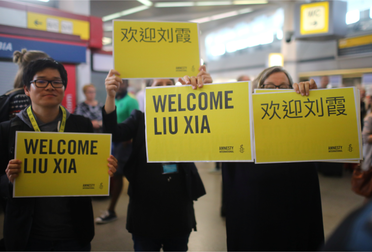 劉霞在台北時間10日晚間11時抵達特格爾機場後,隨即搭乘黑色廂形車離去,未和數十名在機場等候的記者及手持「歡迎劉霞」標語的維權人士交談。圖為劉霞下機後,呼吸到新鮮自由的空氣,不禁攤開雙手,露出久違的開懷笑容。 劉霞在台北時間10日晚間11時抵達特格爾機場後,隨即搭乘黑色廂形車離去,未和數十名在機場等候的記者及手持「歡迎劉霞」標語的維權人士交談。圖為劉霞下機後,呼吸到新鮮自由的空氣,不禁攤開雙手,露出久違的開懷笑容。