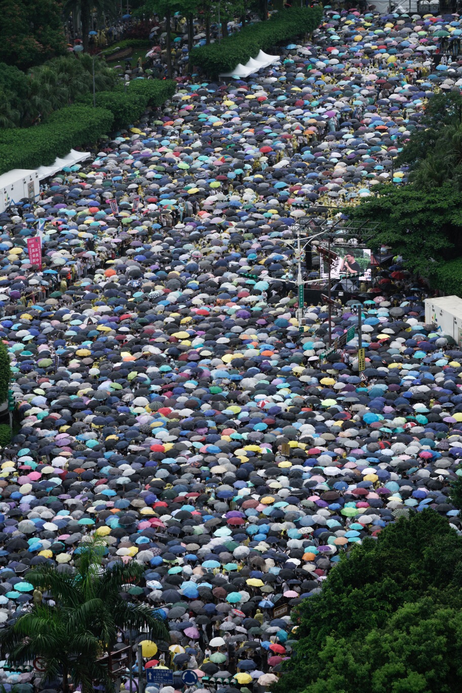今天下午時陣雨,參與反紅媒遊行的民眾,不畏風雨撐起傘、穿起雨衣,一同站在凱道。 圖:張良一/攝影 今天下午時陣雨,參與反紅媒遊行的民眾,不畏風雨撐起傘、穿起雨衣,一同站在凱道。 圖:張良一/攝影