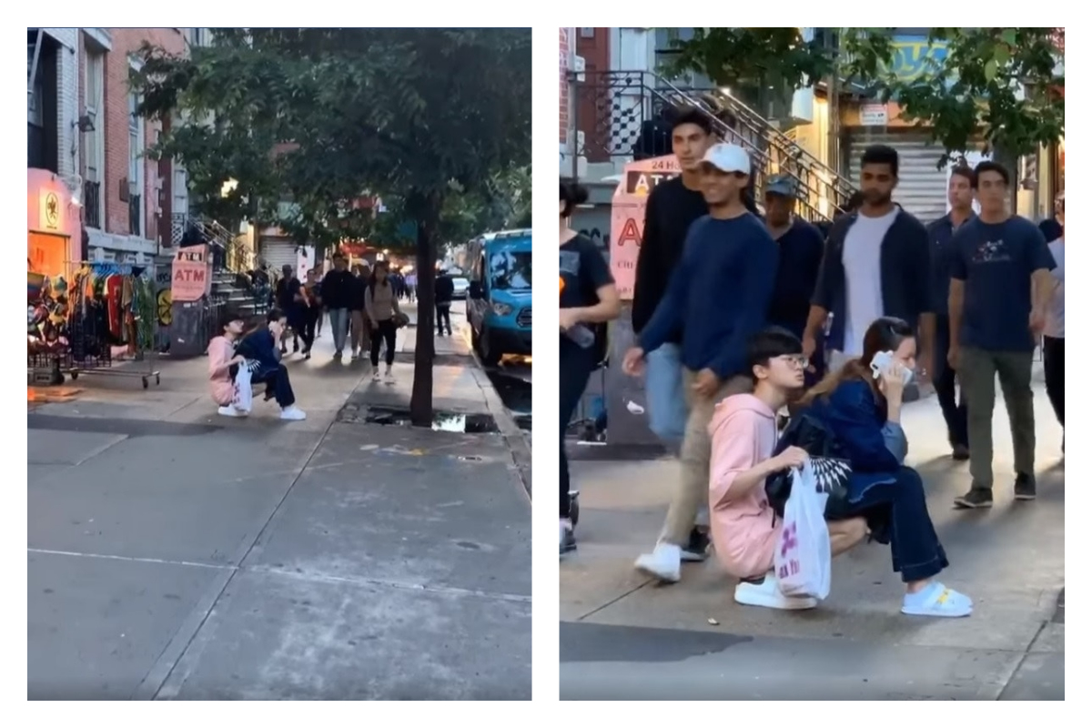 一對情侶大喇喇地坐在路中間,男友蹲著讓女友坐在大腿上講電話,讓網友好傻眼。 圖/翻攝自 What Is New York 臉書影片 一對情侶大喇喇地坐在路中間,男友蹲著讓女友坐在大腿上講電話,讓網友好傻眼。 圖/翻攝自 What Is New York 臉書影片