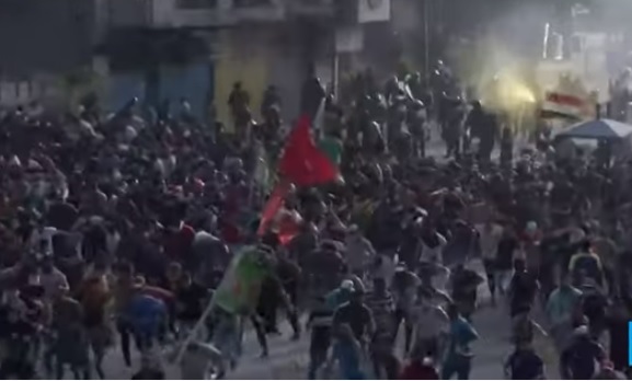 數以千計的伊拉克民眾不顧實彈和催淚瓦斯威脅走上街頭,至少造成19人死亡、400多人受傷。 圖:翻攝Youtube 數以千計的伊拉克民眾不顧實彈和催淚瓦斯威脅走上街頭,至少造成19人死亡、400多人受傷。 圖:翻攝Youtube