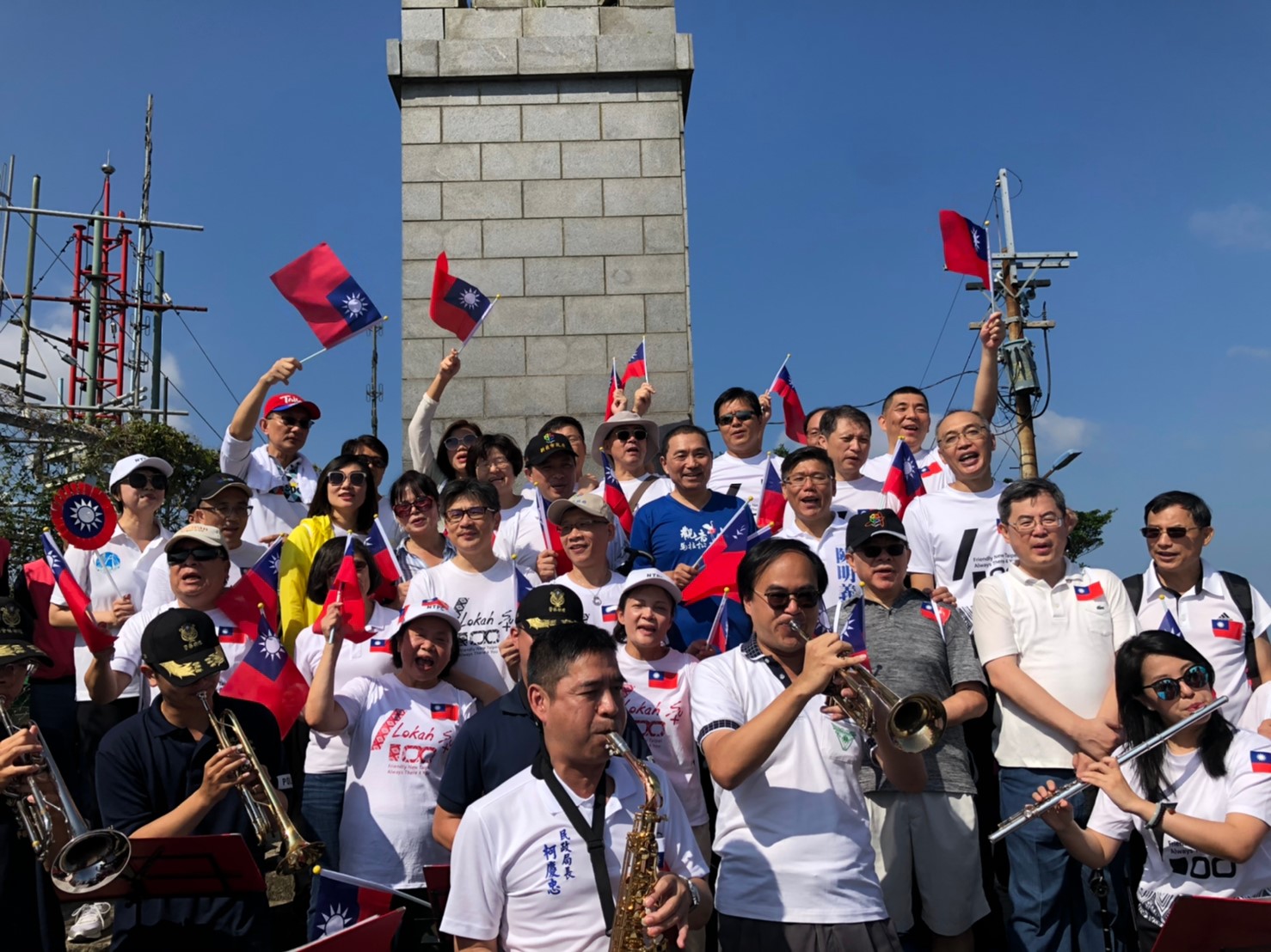侯友宜及市府團隊攀登硬漢嶺,登頂後大家一起揮舞千面國旗,並在自備樂器演奏下,高唱國旗歌展現愛國心。 圖:新北市民政局提供 侯友宜及市府團隊攀登硬漢嶺,登頂後大家一起揮舞千面國旗,並在自備樂器演奏下,高唱國旗歌展現愛國心。 圖:新北市民政局提供