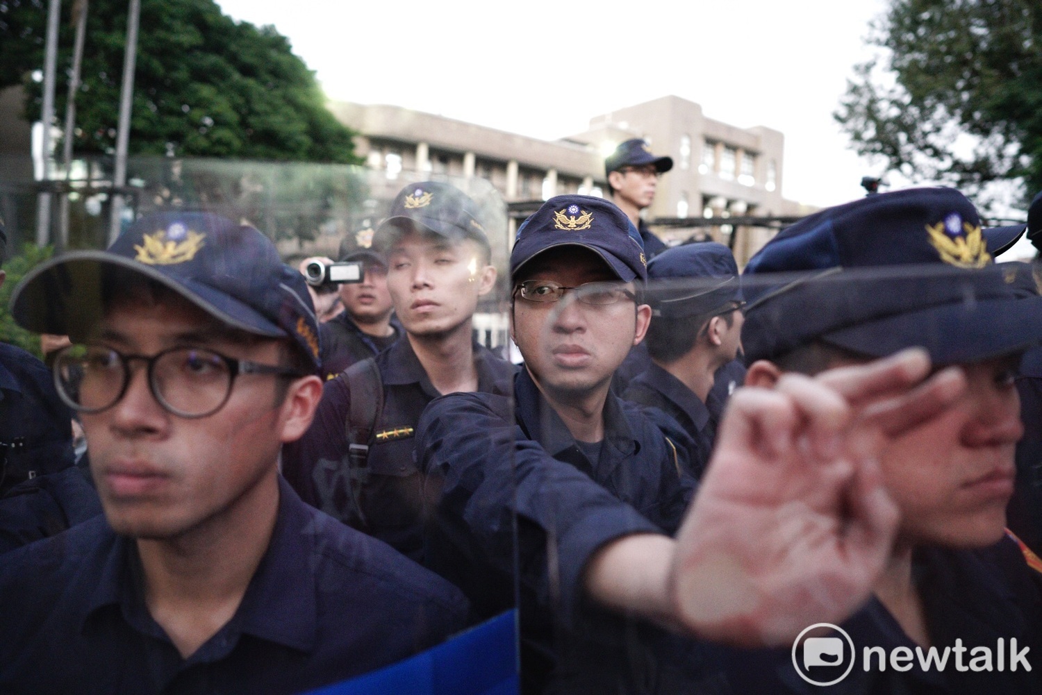 警方在行政院外架拒馬並高舉盾牌防止退警衝進行政院。 圖:張良一/攝 警方在行政院外架拒馬並高舉盾牌防止退警衝進行政院。 圖:張良一/攝