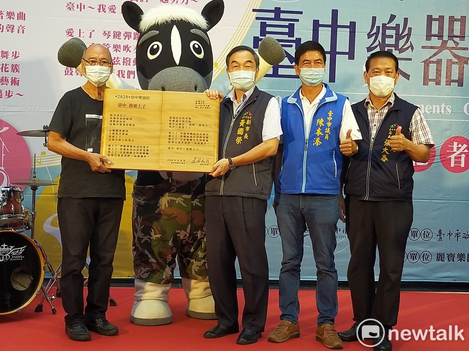 音樂人鈕大可(左一)將主題曲「台中,我愛上了」歌詞木刻版致贈給台中市政府。。 圖:唐復年/攝 音樂人鈕大可(左一)將主題曲「台中,我愛上了」歌詞木刻版致贈給台中市政府。。 圖:唐復年/攝