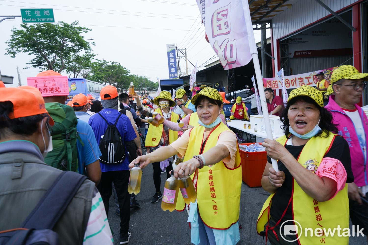 白沙屯媽祖的信眾在彰化花壇中山路上遞水給香燈腳們。 圖:張良一/攝 白沙屯媽祖的信眾在彰化花壇中山路上遞水給香燈腳們。 圖:張良一/攝