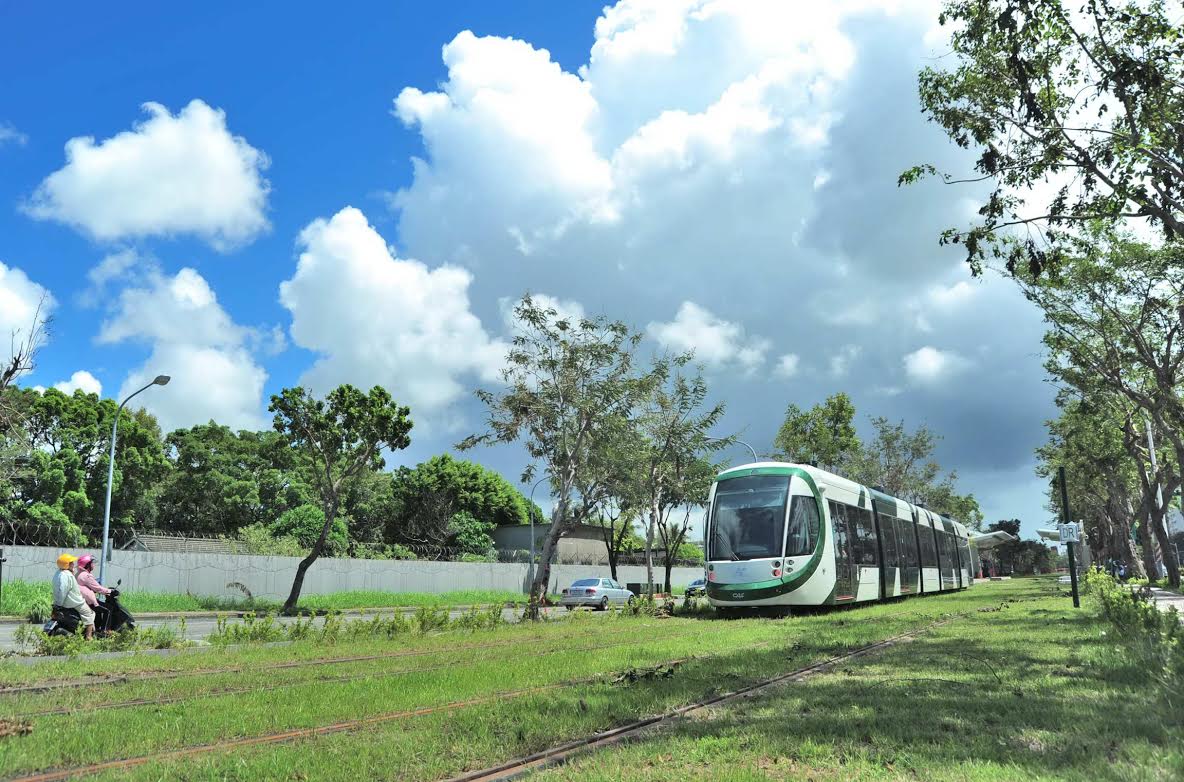 輕軌上路象徵高雄在綠能公共運具、節能減碳大躍進,輕軌列車穿捘綠意盎然的市區道路,頻添高雄都市風情。圖:高雄市政府提供 輕軌上路象徵高雄在綠能公共運具、節能減碳大躍進,輕軌列車穿捘綠意盎然的市區道路,頻添高雄都市風情。圖:高雄市政府提供