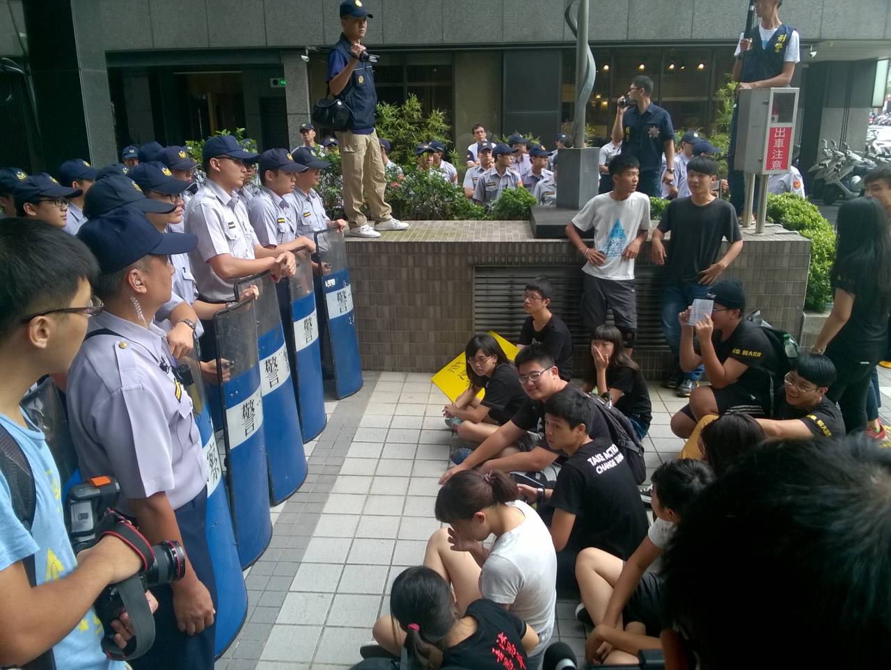 經過15分鐘的推擠,學生仍未能進入國教院,隨即重整隊伍,繼續靜坐。圖:何星瑩/攝 經過15分鐘的推擠,學生仍未能進入國教院,隨即重整隊伍,繼續靜坐。圖:何星瑩/攝