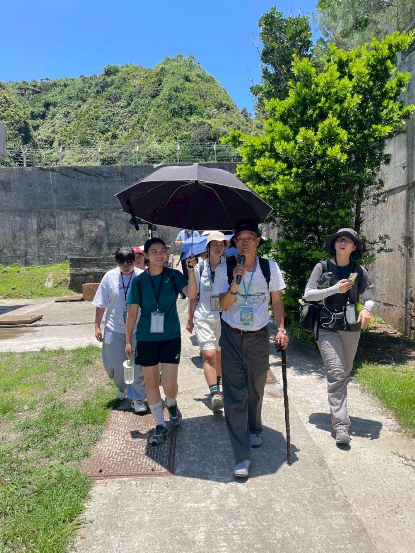  白色恐怖受難者黃瑞麟帶領高中師生於「綠洲山莊」進行走讀活動。 圖：教育部提供 