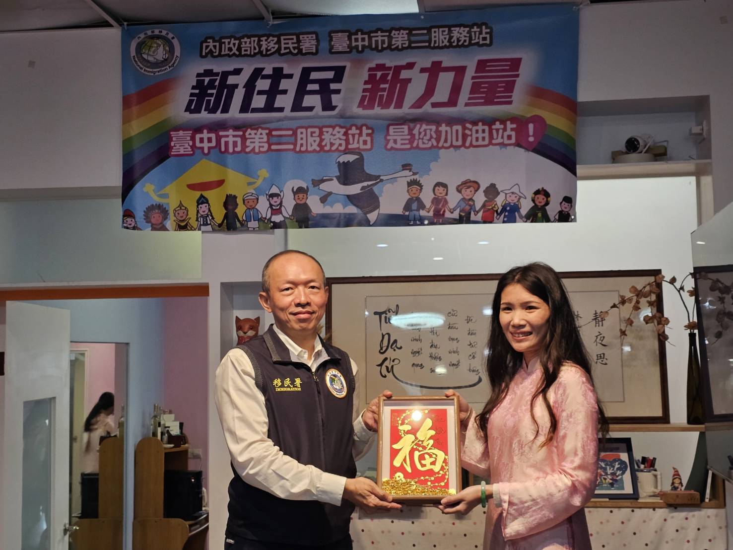  熱愛書法的阮芳誼(右)準備了親手繪製的馬年春聯送給在場的嘉賓們，作為新春祝福 圖：移民署 / 提供 