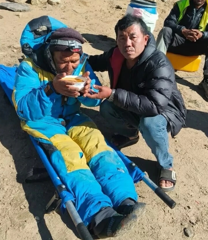 獲救的雪巴嚮導達瓦喝熱湯保溫。 圖 : 翻攝自極目新聞 
