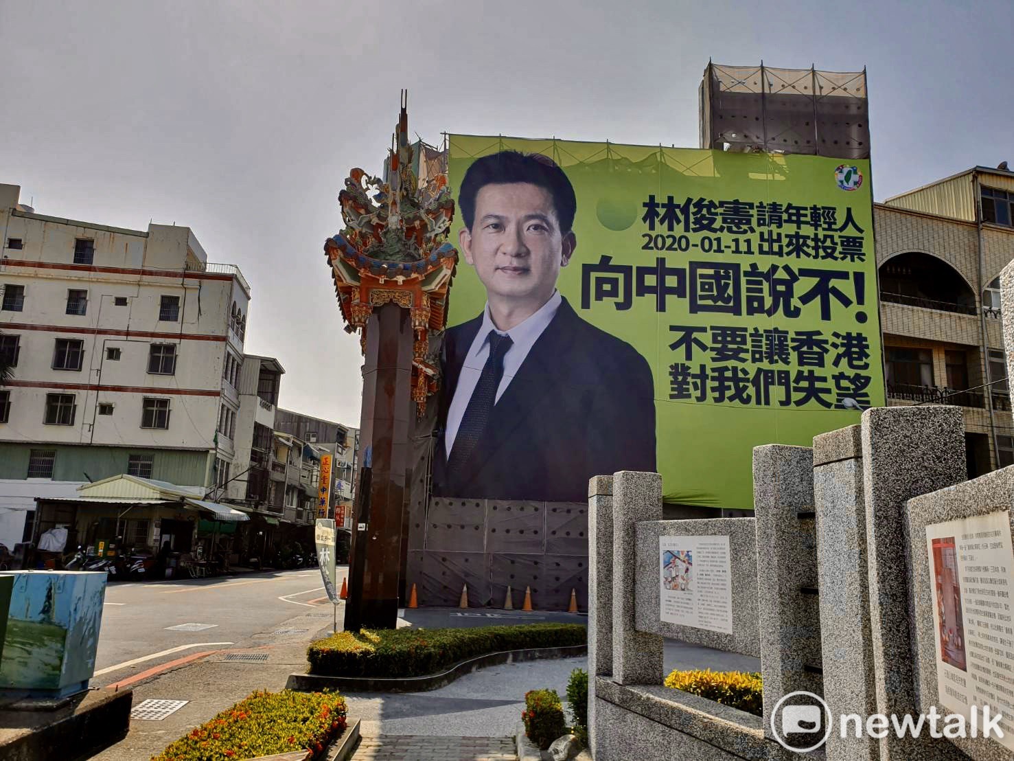 香港陷於「反送中」動盪，民進黨立委林俊憲為此趕工製作大型街頭看板，呼籲年輕人以選票向中國說不。   圖：黃博郎／攝