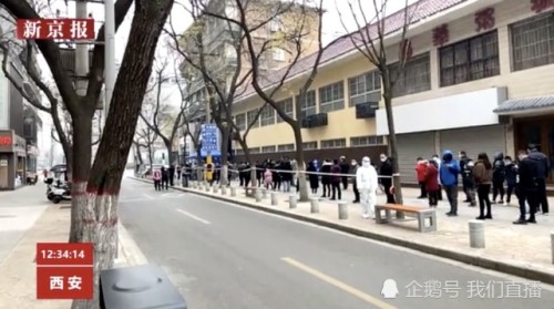 中國西安市COVID-19疫情再度爆發，民眾排隊等待進行核酸檢測。   圖 : 翻攝騰訊網