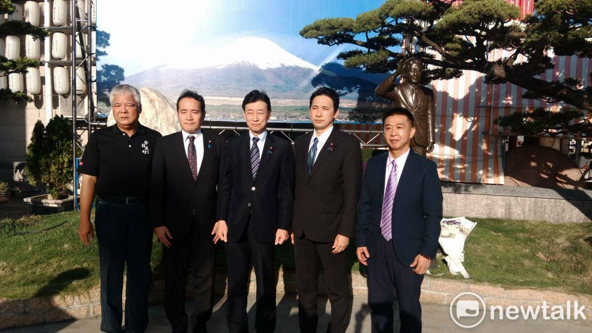 西村康稔(中)在安倍銅像與刻有「台灣加油」的石頭前合影。   圖：孫家銘/攝