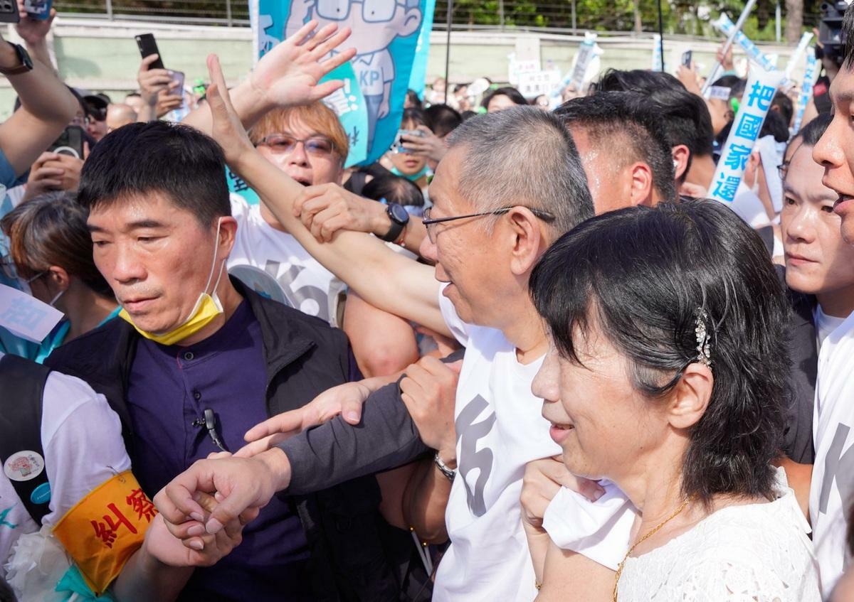  前民眾黨主席柯文哲在小草簇擁下走上座車。 圖：張良一/攝 